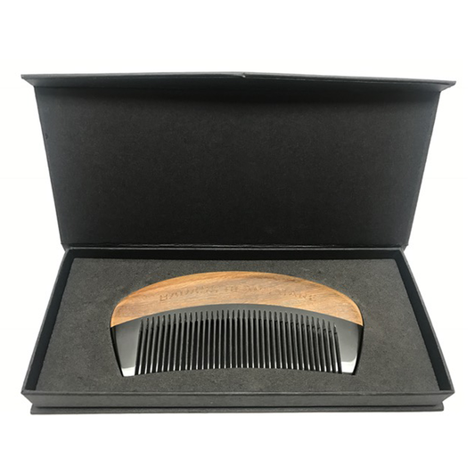 Ox horn comb with sandalwood finish from Badass Beard Care, displayed in a protective case, ideal for beard and hair grooming.