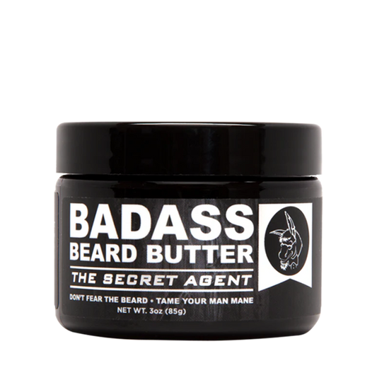 Container of Badass Beard Care Secret Agent Beard Butter showing the creamy beard conditioning butter in a natural setting.
